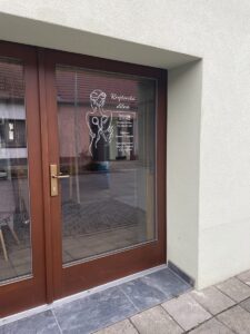 Polep provozních údajů na vstupní dveře do krejčovské dílny